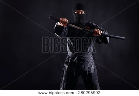 Ninja With Katana On A Dark Background