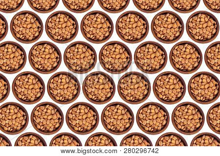 Unpeeled Apricot Stone In A Wooden Cedar Plate On A White Isolated Background. Row Of Bowls With Apr