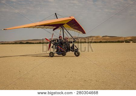 Walvis Bay, Namibia - July 16, 2018: An Ultralight Aircraft Takes Off From An Improved Dirt Runway I