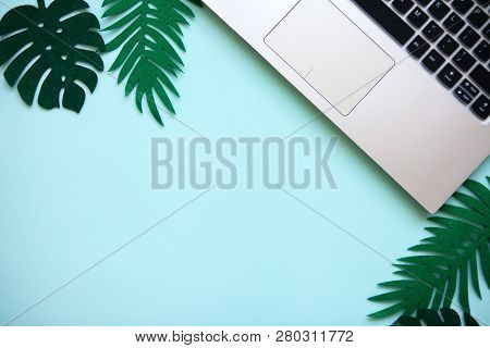 Workspace In A Blue Trendy Color Or Summer Design With A Concept To Start A Vacation. Laptop And Nex