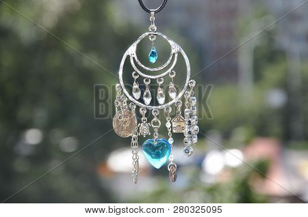 Some Believe In Luck. Name Amulet For Good Luck. Luck Amulet Hung Out Outdoor. Silver Amulet With Ge