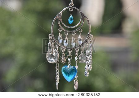 A Magical Spell. Silver Amulet With Gems And Pendants. Believing In Magic Protecting The Holder Of A