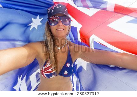 Proudly Australian Woman Bears The Australian Flag On Her Hat, Sunglasses And Bikini While Holding A