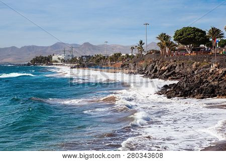 Puerto Del Carmen Beach In Lanzarote, Canary Islands, Spain. Blue Sea, Palm Trees, Selective Focus