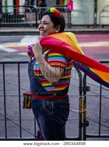 San Francisco, California, June 24, 2018:  Gay Pride Parade - Woman Wears Rainbow Shirt And Cape In 