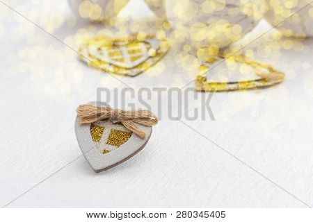 A Small Homemade Carton Heart With Gold Sparkles On A White Background With Gold Boke. Light Fon Wit