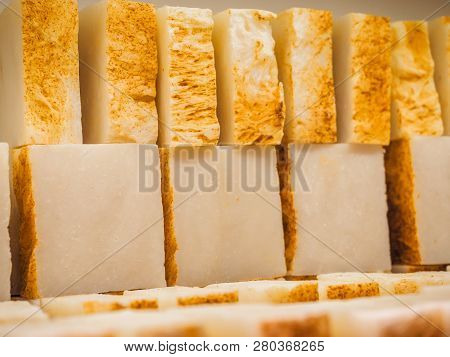 Bars Of Soap On A Shop Window. Turmeric Soap With Natural Cedar Oil And Herbal Ingredients. Handmade