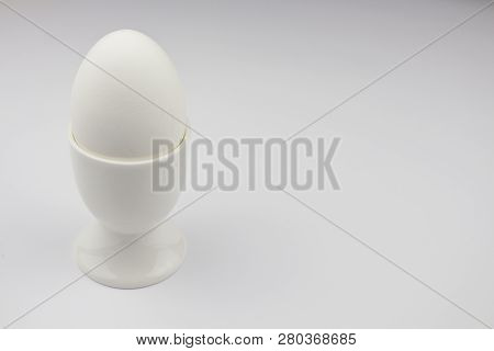 Boiled Egg On White Background, Isolate. Egg In Stand, Space For Text