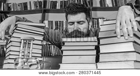 Man On Sleeping Face Lay Between Piles Of Books, Fall Asleep While Studying In Library, Bookshelves 