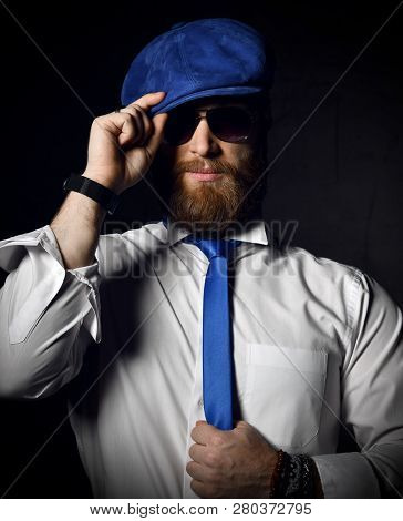 Stylish Bearded Man In White Shirt And Sunglesses Holds His Blue Cap Hat And Tie Greeting
