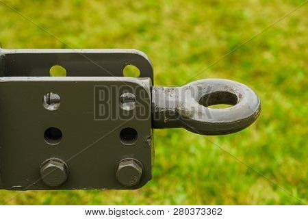 Close Up On Dark Towbar In Agricultural Machine Vehicle. Green Grass In Backround.