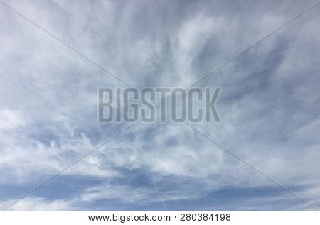 Beautiful Snowy Clouds Against A Blue Sky Background. Sky Cloud. Blue Sky With Winter Clouds Weather