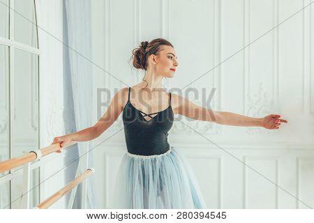 Young Classical Ballet Dancer Woman In Dance Class. Beautiful Graceful Ballerina Practice Ballet Pos