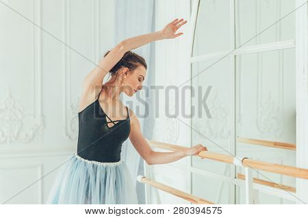 Young Classical Ballet Dancer Woman In Dance Class. Beautiful Graceful Ballerina Practice Ballet Pos