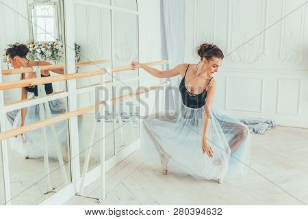 Young Classical Ballet Dancer Woman In Dance Class. Beautiful Graceful Ballerina Practice Ballet Pos