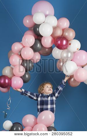 Young Happy Child Lets Pink, Grey And White Ballons To Fly In A High On Blue Background. Child Jumps