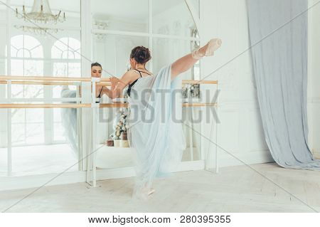 Young Classical Ballet Dancer Woman In Dance Class. Beautiful Graceful Ballerina Practice Ballet Pos