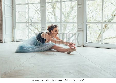 Young Classical Ballet Dancer Woman In Dance Class. Beautiful Graceful Ballerina Practice Ballet Pos