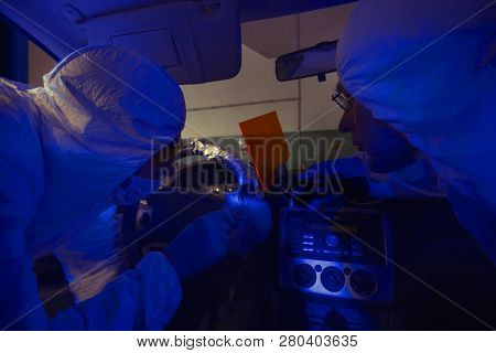 Crime Investigation - Looking For Evidences And Traces In Suspected Car In Police Garage Under Uv Li