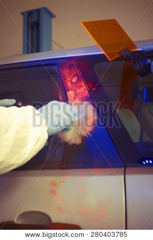 Crime Investigation - Developing Of Fingerprints On Suspected Car In Police Garage Under Uv Light