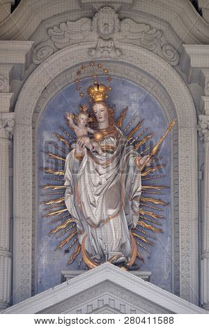 LUCERNE, SWITZERLAND - JUNE 24, 2018: Virgin Mary with baby Jesus, statue on the portal of the church of St. Leodegar in Lucerne, Switzerland