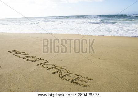 Inscription #plasticfree Written On The Sand On The Shores Of The Atlantic Ocean