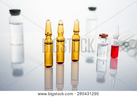Group Of Vials With Medication On Blue Methacrylate Table. Horizontal Composition.