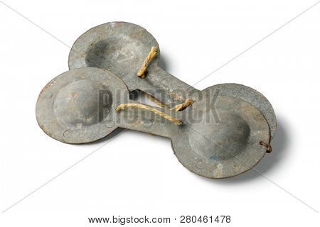 Single traditional iron Moroccan krakebs used in Gnawa music isolated on white background