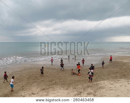 Anyer, Indonesia - June 26, 2018: Some Boys Play Football On The Sand Beach Of Sambolo Anyer.