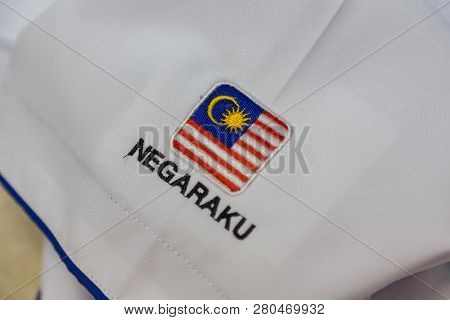 Close-up Of Embroidery Malaysia Logo With Wording Negaraku (my Country) On White Uniform