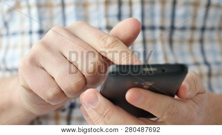 Close-up Of Hands Holding Smartphone, Typing Text On Touch Screen And Using Applications. A Person T