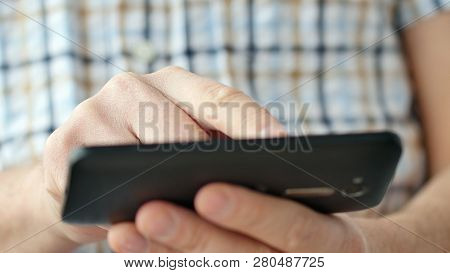Close-up Of Hands Holding Smartphone, Typing Text On Touch Screen And Using Applications. A Person T
