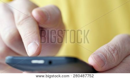Close-up Of Hands Holding Smartphone, Typing Text On Touch Screen And Using Applications. A Person T