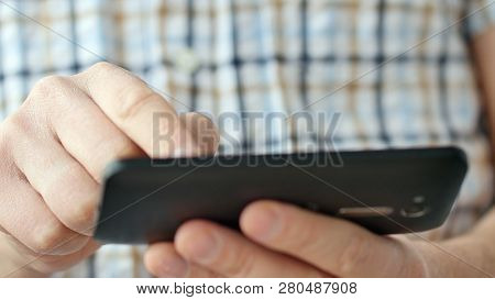 Close-up Of Hands Holding Smartphone, Typing Text On Touch Screen And Using Applications. A Person T