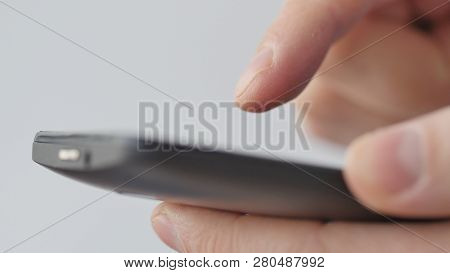 Close-up Of Hands Holding Smartphone, Typing Text On Touch Screen And Using Applications. A Person T