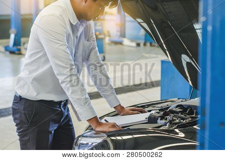 This Career Man Saleman Business Inspection Writing Note On Notepad Or Book, Paper With Car Blurry B