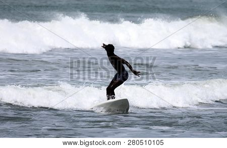 Surfer Surfing The Waces In The Gambia