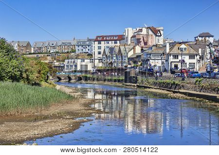 6 July 2018: Bude, Cornwall, Uk - Homes And Businesses In The Seaside Town, Reflected In The River N