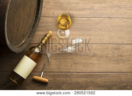 Bottle Of White Wine With Label On Old Board. Wine Bottle And Glass With Barrel Background