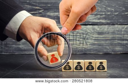 Businessman Removes A Cube With A Picture Of Dollars. Financial And Economic Crisis. Capital Outflow