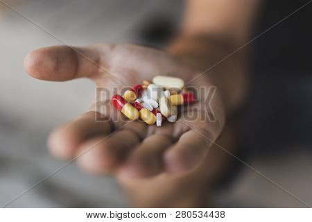 Close Up Of A Handful Of Different Pills And Capsules. Selective Focus On The Pills