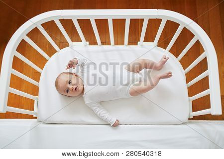 Baby Girl In Co-sleeper Crib