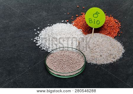 Garden Background With Mineral Fertilizers Balls. Complex Mineral Fertilizer With Sodium, Phosphorus