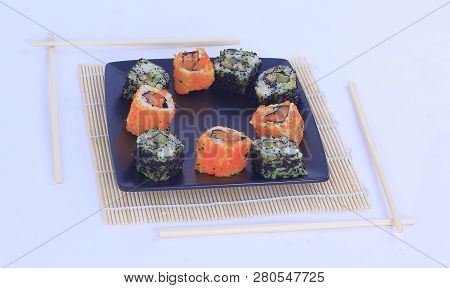 Different Types Of Maki Sushi On A Black Plate