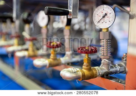 Pressure Measuring Instrument - Bar, Psi. Red Metal Valves On The Pipes. Pressure Device For Industr