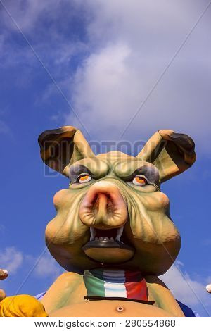Putignano, Apulia, Italy - February 15, 2015: Carnival Floats, Giant Paper Mache. Pig With Bib Of Th