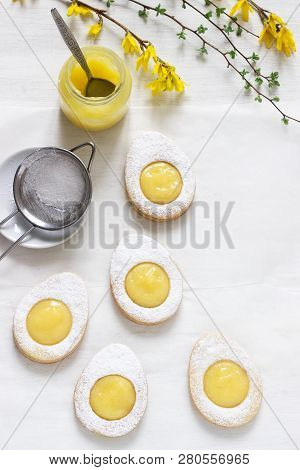 Homemade Easter Lemon Cookies And Forsythia Blooming Twigs On A Light Background.