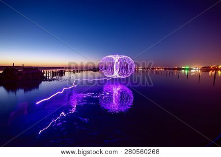 Amazing Laser Fireshow Performance In The Night Blue Sky With Reflections In The Sea Water