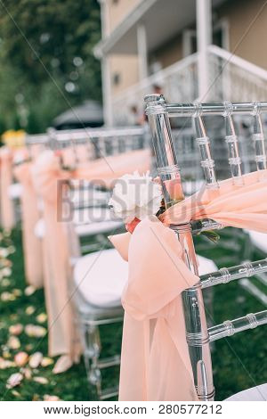 Square Wedding Ceremony. Transparent Chairs Are Decorated With Flowers, Greenery. Cute, Trendy Svdeb