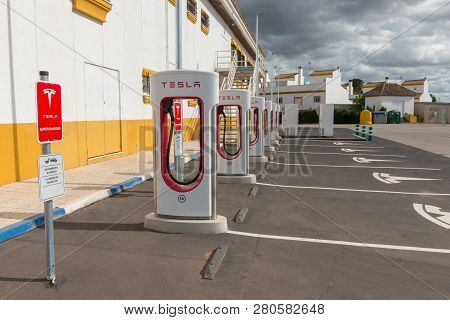 Aguadulce, Seville, Spain - April 29, 2018: A Tesla Electric Supercharger Stand At A Gas Station In 